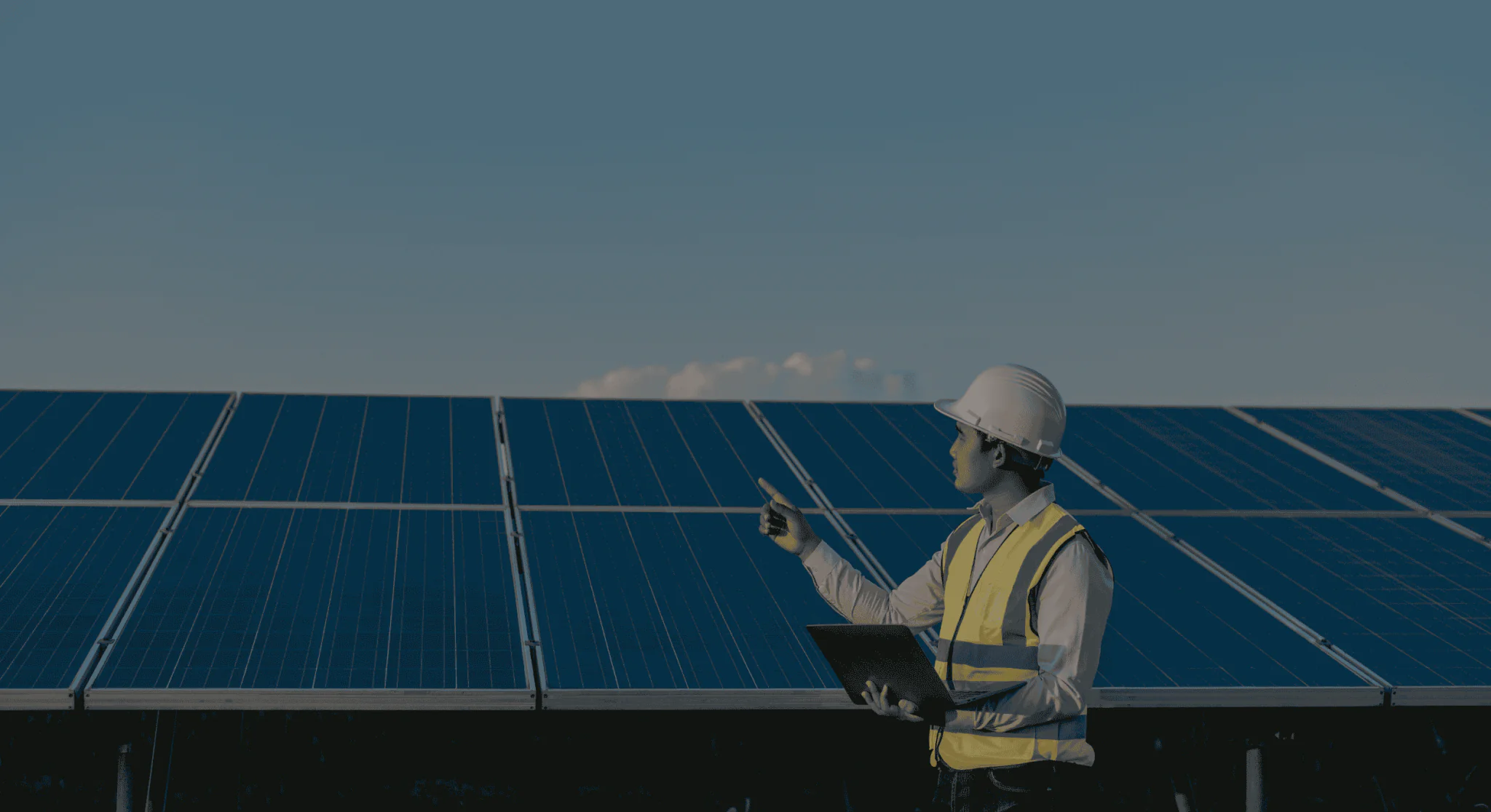 solar farm technician monitoring panels through a saas platform