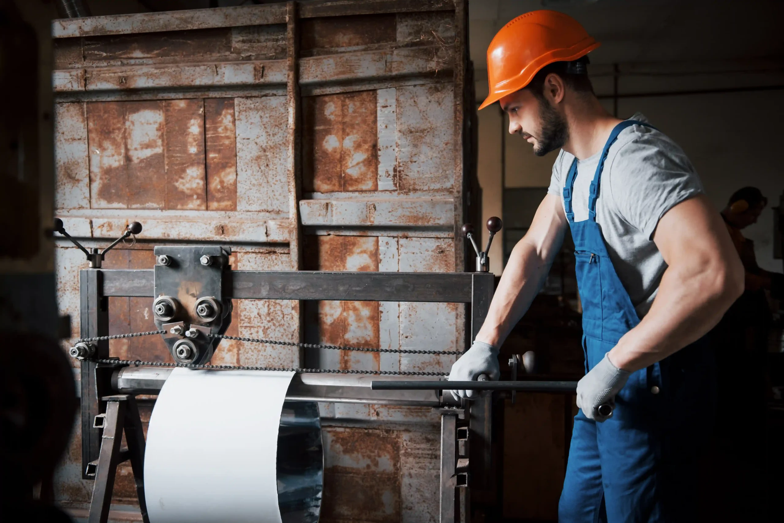 paper & process manufacturing worker in hard hat at a large metalworking plant for paper and process manufacturing